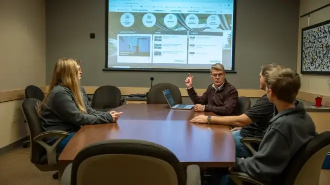 Meeting room presentation pointing at board